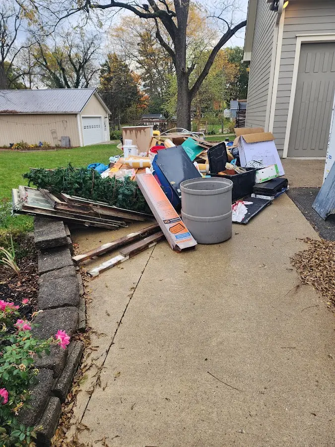 Dumpster being loaded with debris for Commercial Dumpster Rental in Seaford